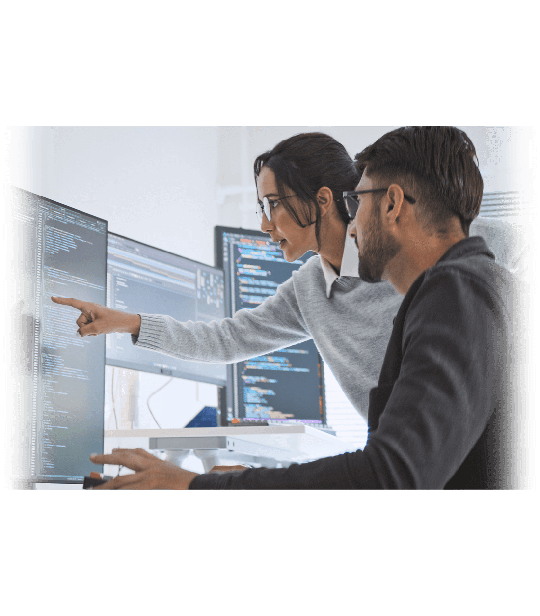 a woman and man looking at a computer screen